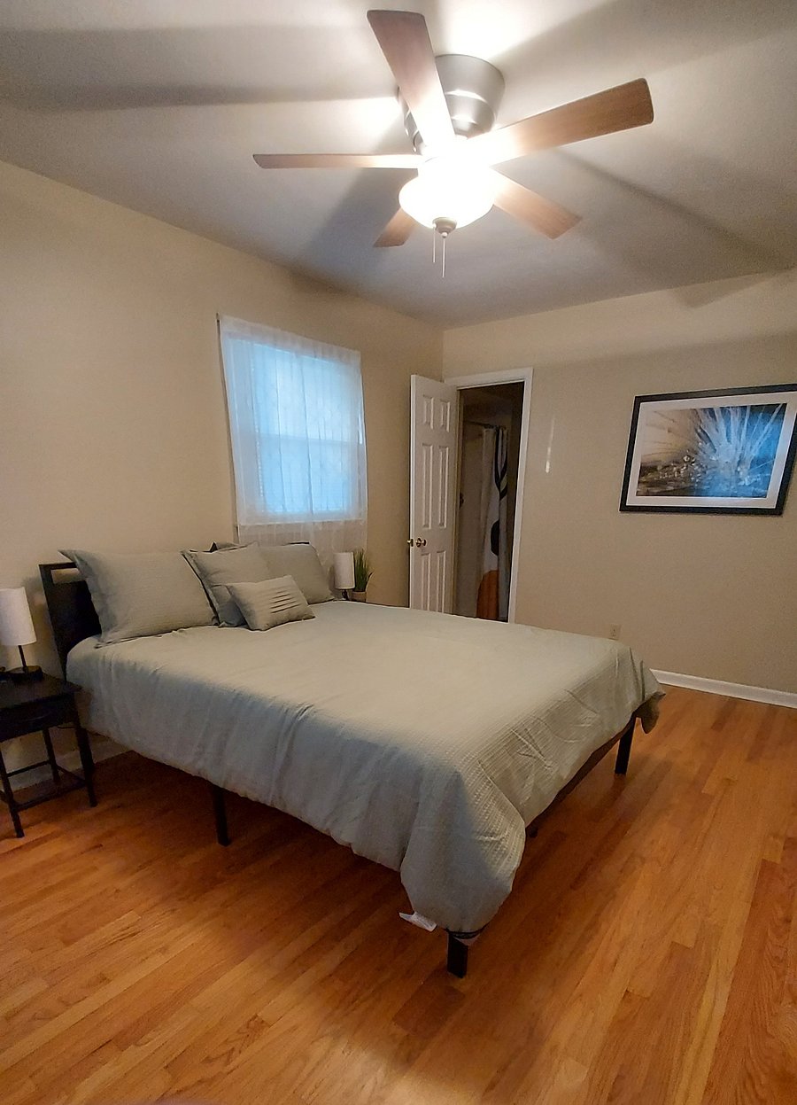 Master bedroom with queen bed and bathroom