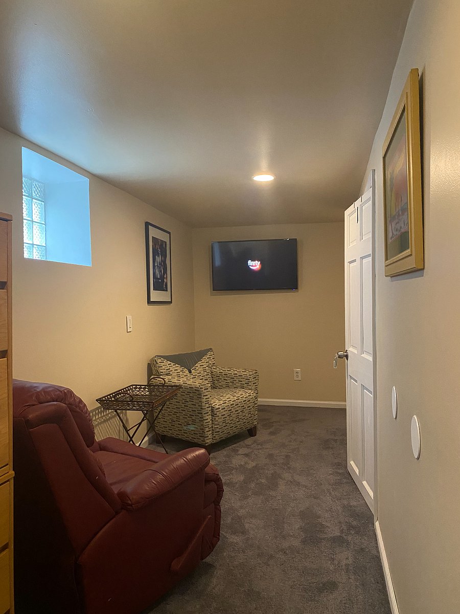 Basement Common Area: Recliner, Accent Chair and TV with Firestick.