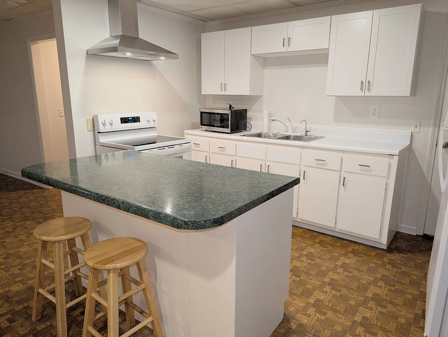 Full kitchen with new appliances. Cabinets have pots, pans, dishes, silverware, and gourmet cookware. It is clean and bright