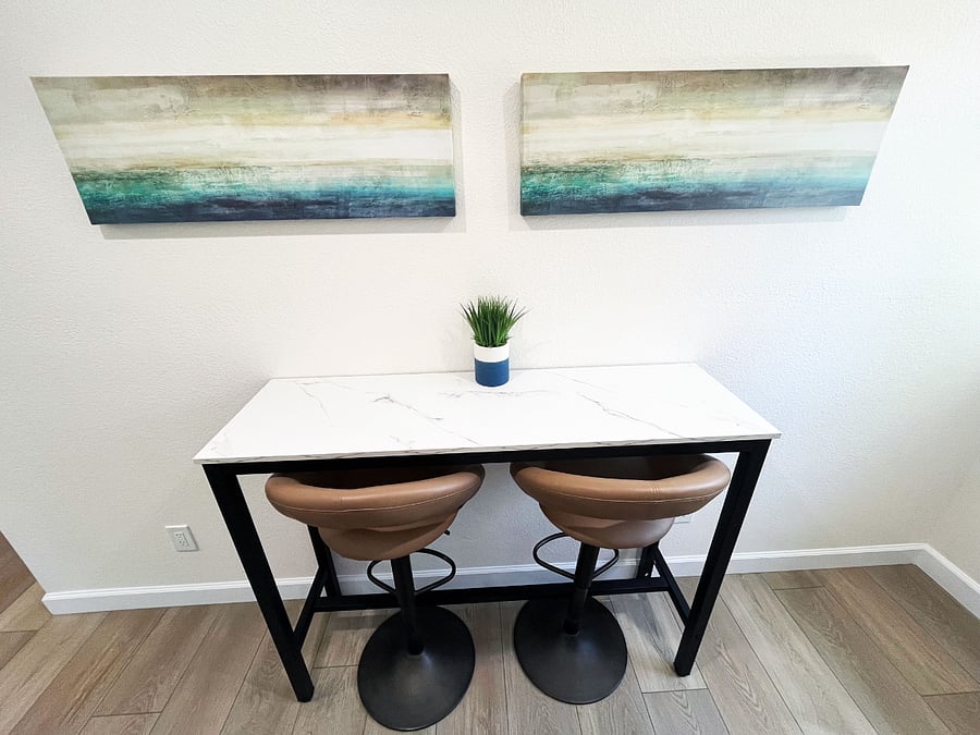 Eat or work on the high-top table seated on comfortable, adjustable barstools.