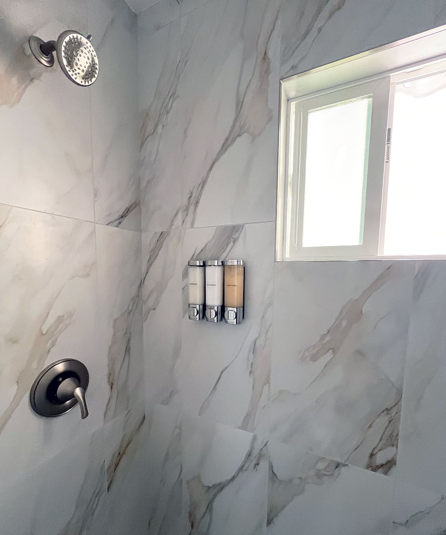 Wall-mounted shampoo, conditioner, and soap are provided for you