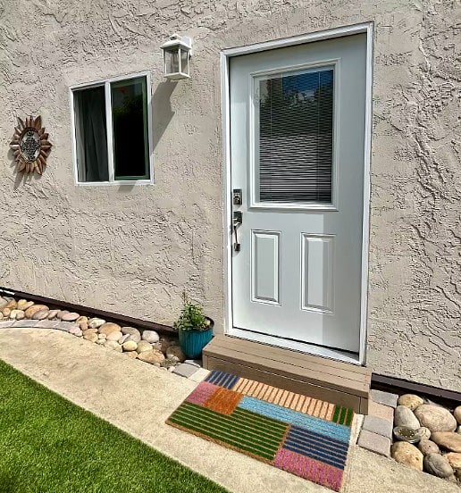 The front door entrance is shown here with windows providing natural light to the living room.