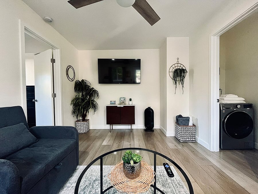 TV and laundry area shown.
