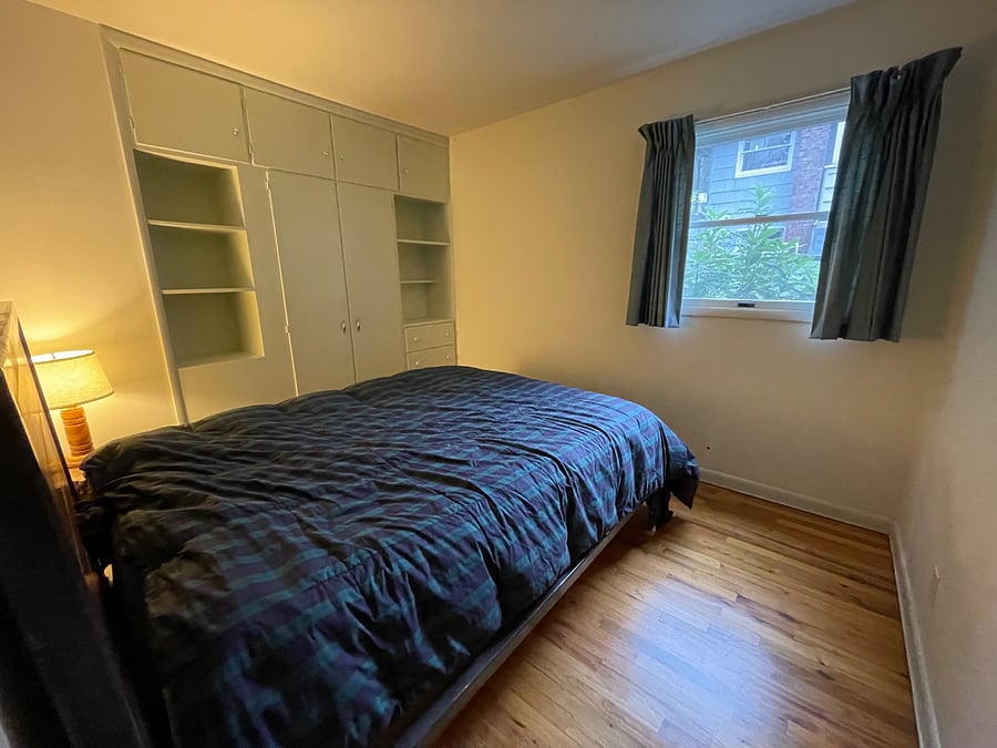 Small bedroom with built in closet and dresser