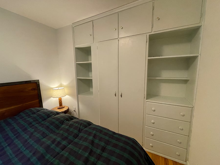 Small bedroom with built in closet and dresser