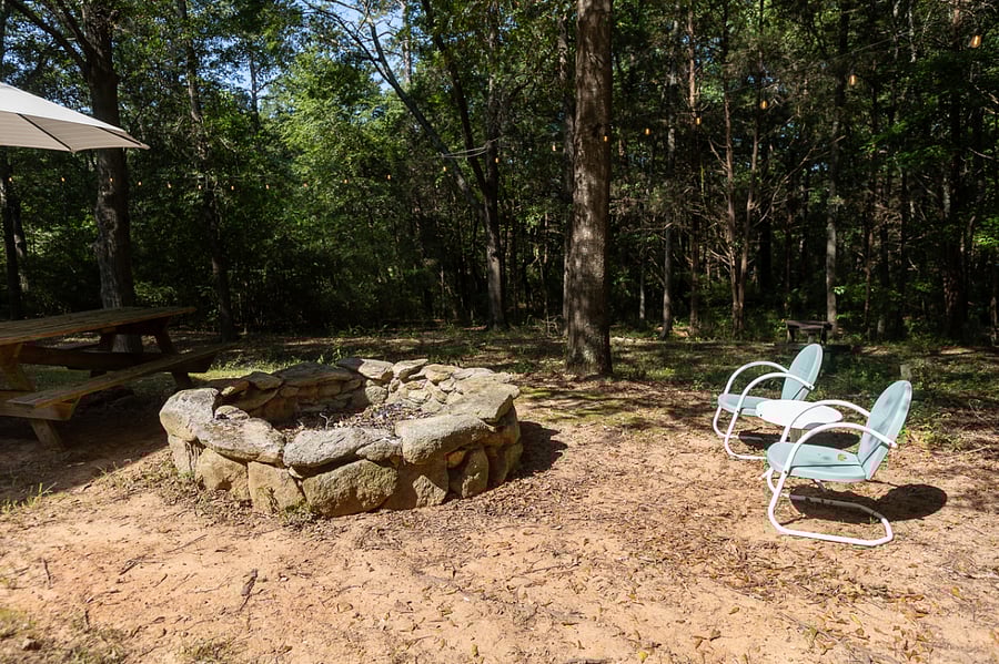 Large fire pit, picnic table and additional chairs.