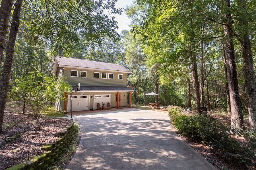 Front of house. Large driveway pad. Basketball goal. Additional parking on the left side before start of driveway pad. Garage entertainment area not currently available for use.