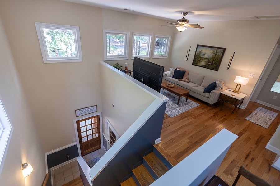 Overview of living area w/stairwell. A lockable gate can be installed at top of stairs, if requested.