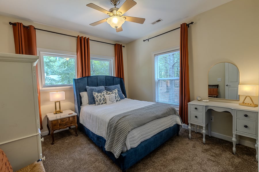 1st bedroom. Queen. Vanity, vanity stool to be added. Touch lamp on vanity w/charging station. Black out curtains.