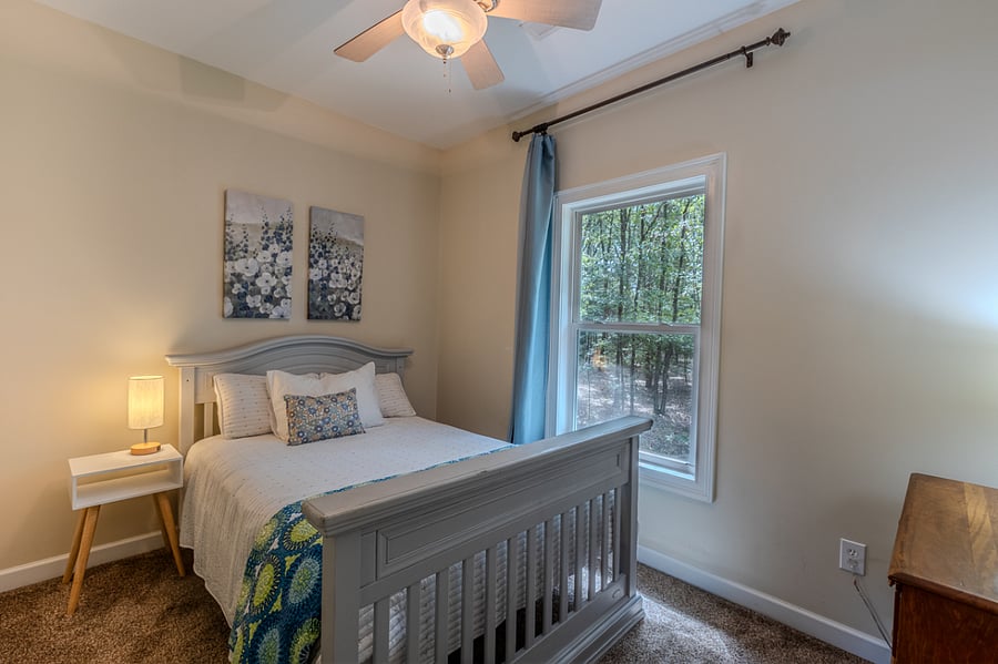 2nd bedroom. Full size bed. Window views back yard. Touch lamp and charge outlets by bed. Nice size closet to the left of bed. 2 levels for hanging clothes and 2 shelves. High ceiling allows for extra storage on top shelf. Hooks on door for extra storage.