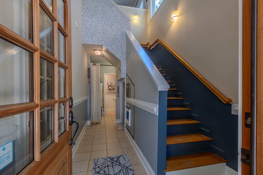 Front door entry. Dog stay space under stairs, laundry area w/LG front load washer/dryer. You can see Hot water heater from front door, but it is coverable w/curtain. Half bathroom downstairs. Garage entertainment space currently unavailable.