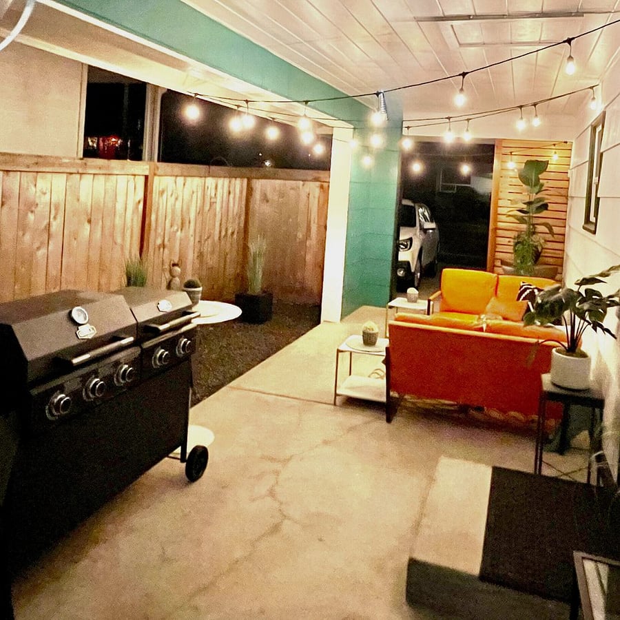 Outdoor cooking area located under a covered patio with BBQ and outdoor griddle station available year-round  perfect furnished short-term housing amenity in Tacoma WA for professionals and medical staff.
