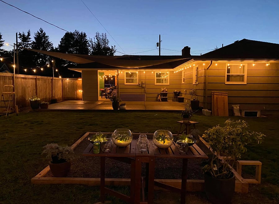 Relaxing outdoor fire pit with live wood bar and live wood bench seating  perfect Tacoma short-term housing perk for relaxing after hospital shifts or contract work.