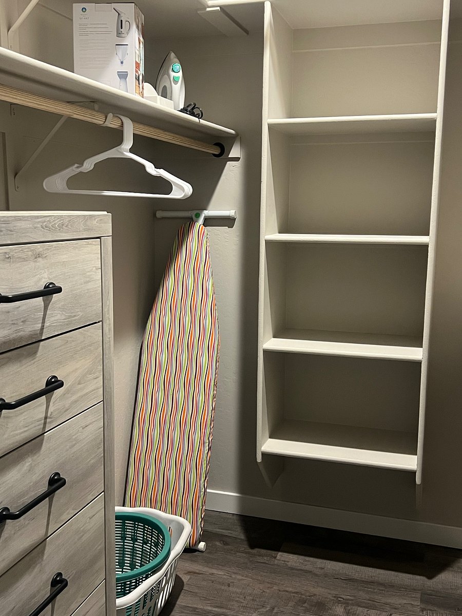 Large walk-in closet in master bedroom with dresser.