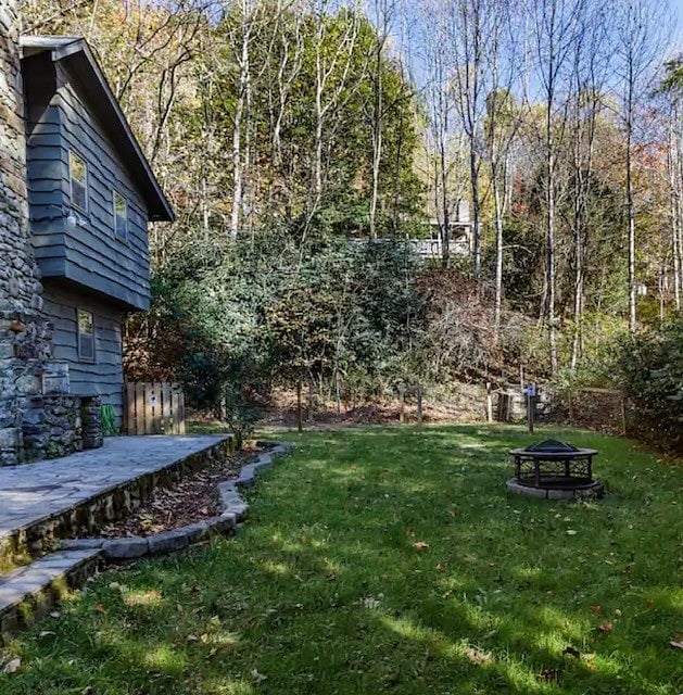Large back yard side yard with wood fire pit 