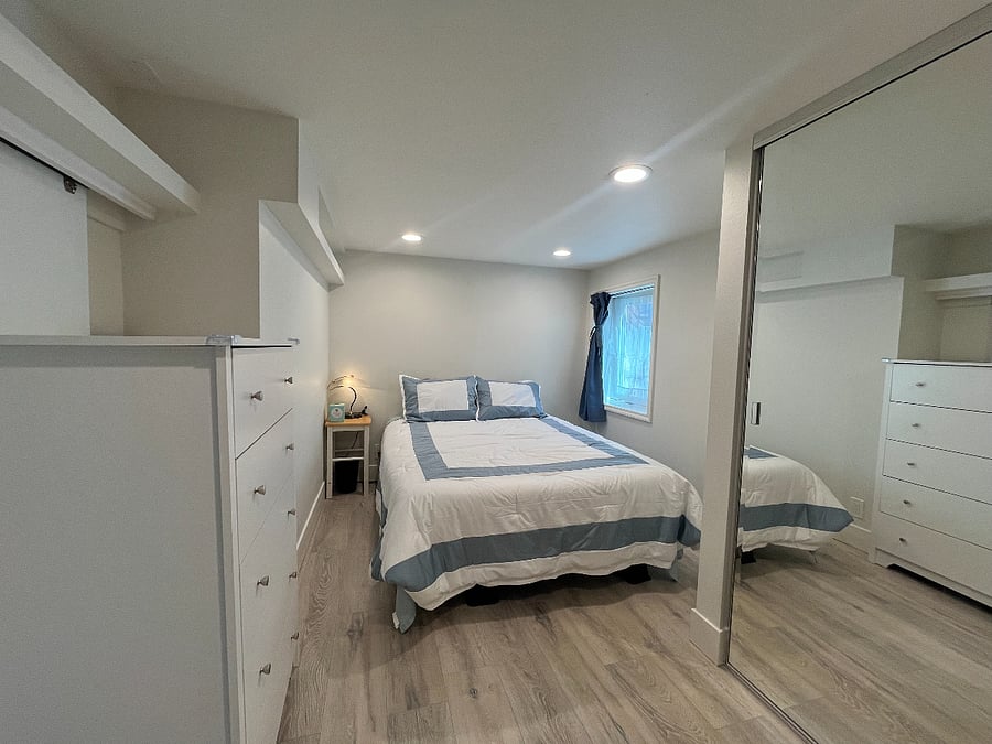 Bedroom one (queen bed) with large mirrored closet.