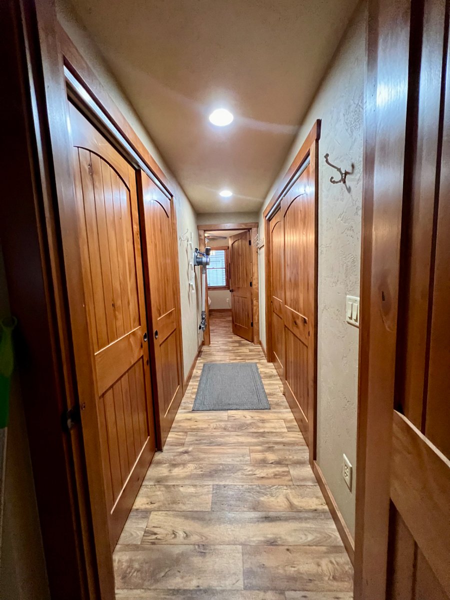 Hallway to primary bedroom, washer, dryer, storage