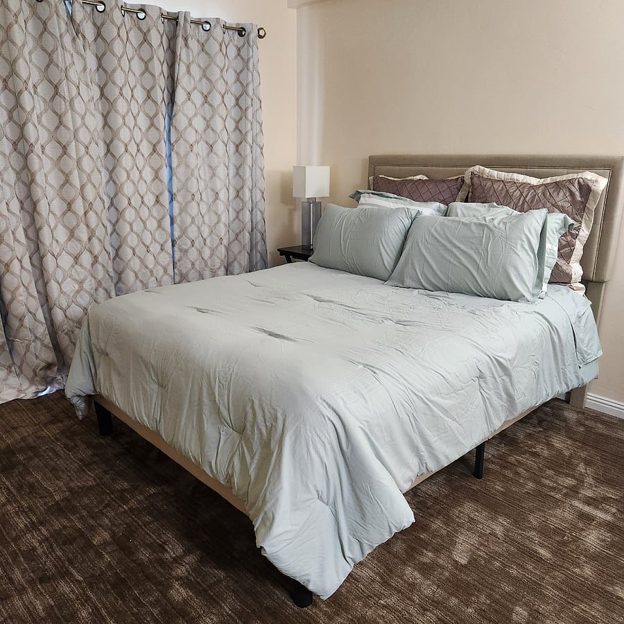 primary queen sized bed & black out curtains