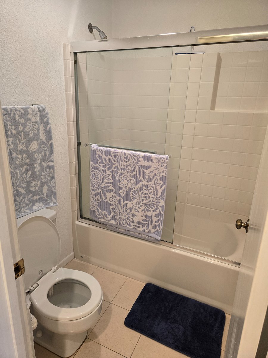 Private bathroom has sink, vanity, toilet, tub and shower