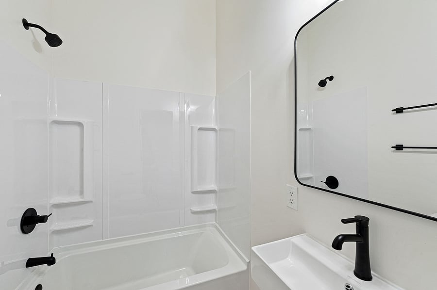 Bathroom with bath/shower combo, sink and toilet.