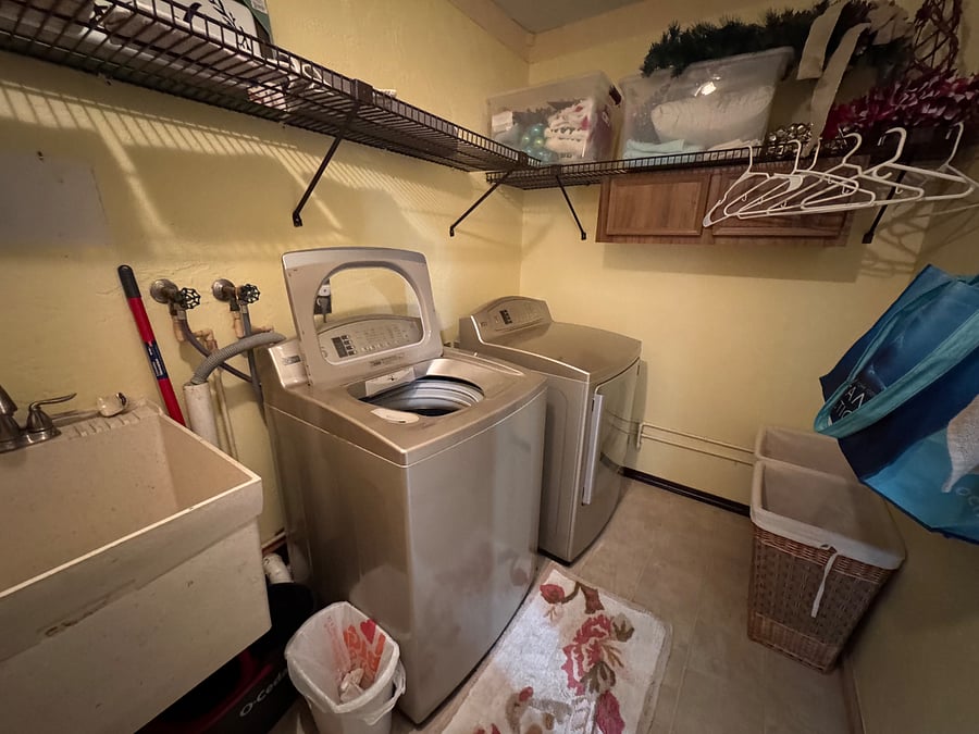 Washer/dryer in garage with utility sink 