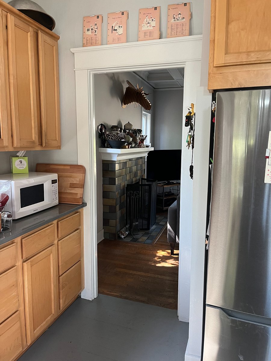 Kitchen with view of living room fireplace