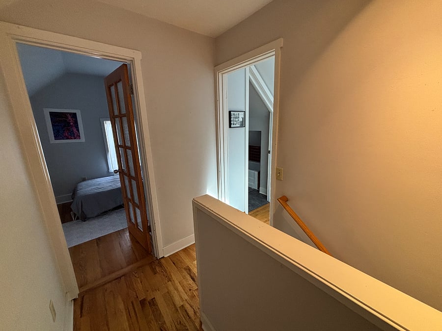 upper floor- view from top of stairs- small bedroom on left, bathroom and office on right,