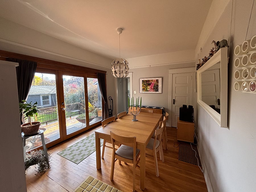 Dining room with glass doors - view to kitchen- there is a door and stairs to basement bathroom & laundry between kitchen and dining room.