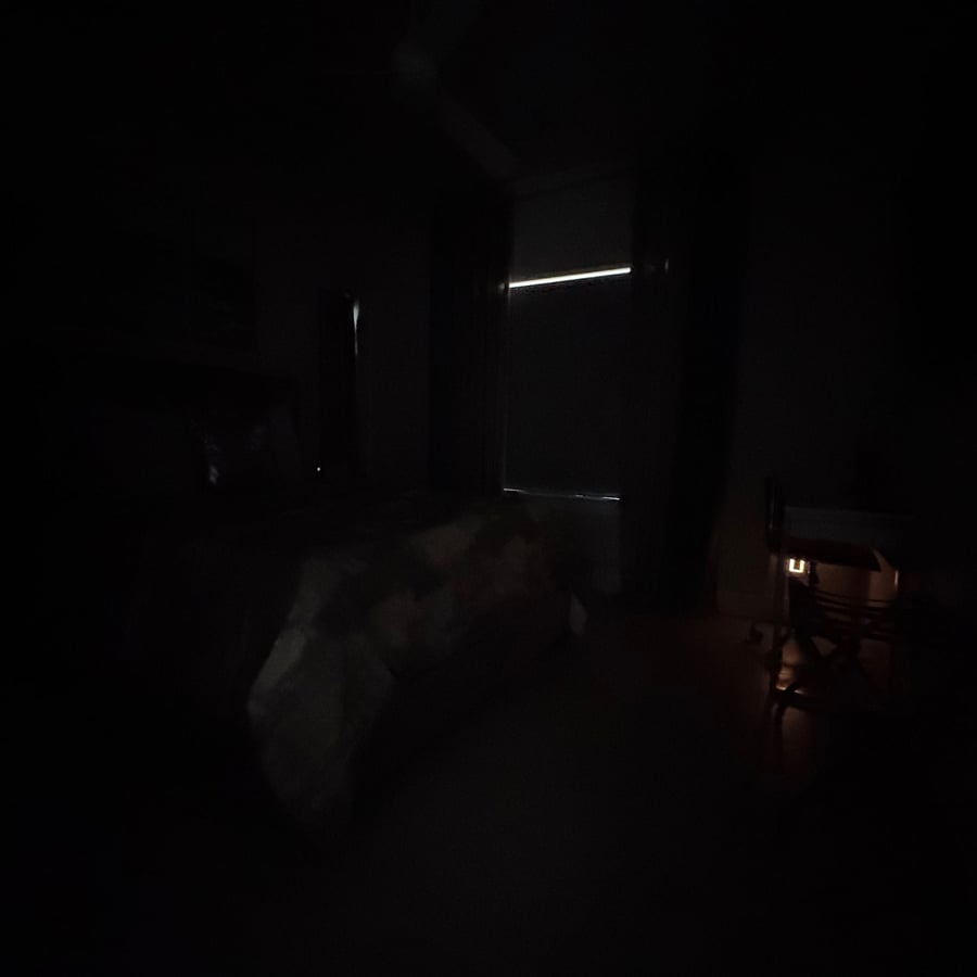 Room with all lights off and shade closed.