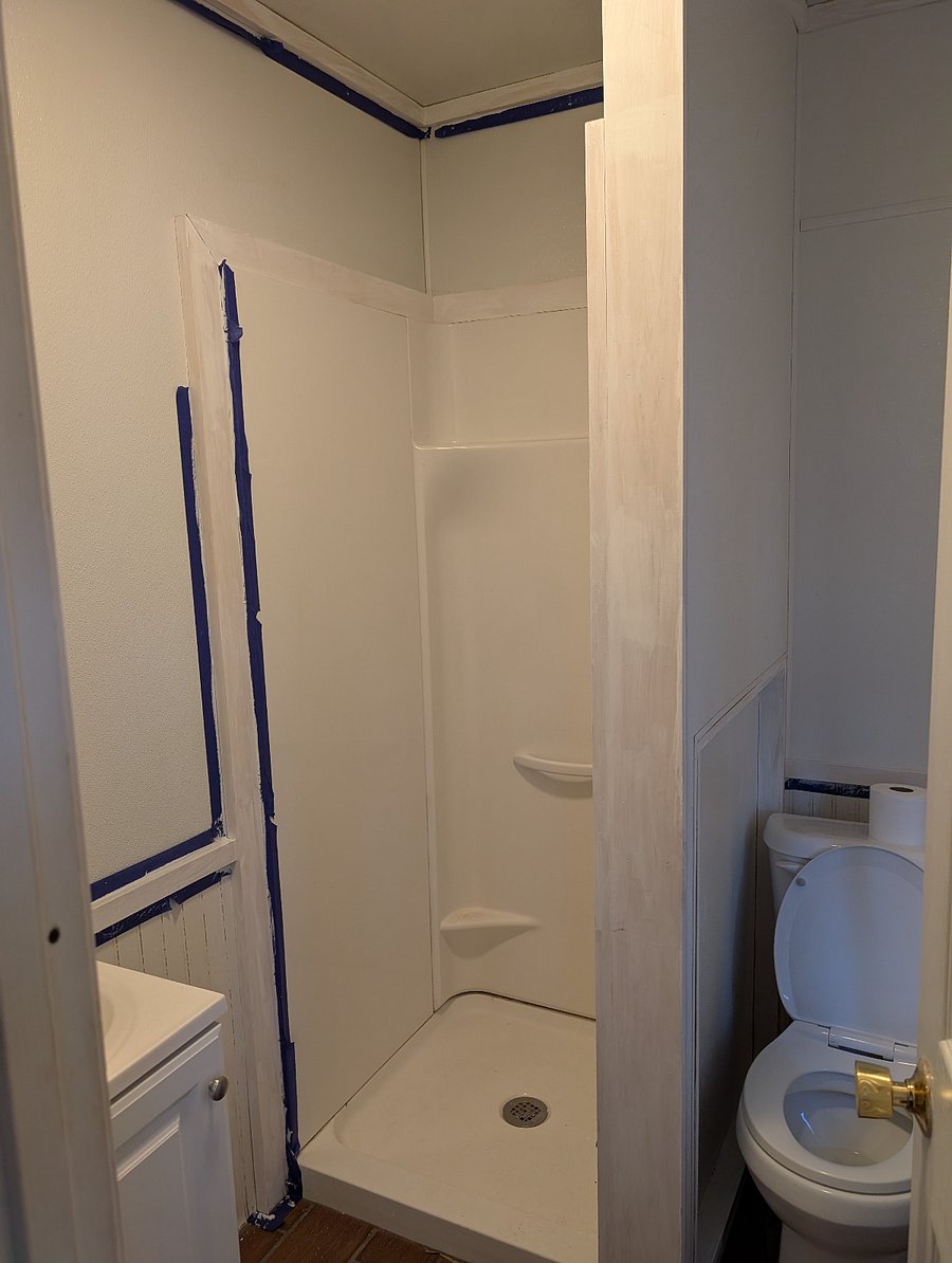 The only picture I took of the bathroom was during painting. It is small, with a vanity, standup shower, and toilet. It gets nice light.