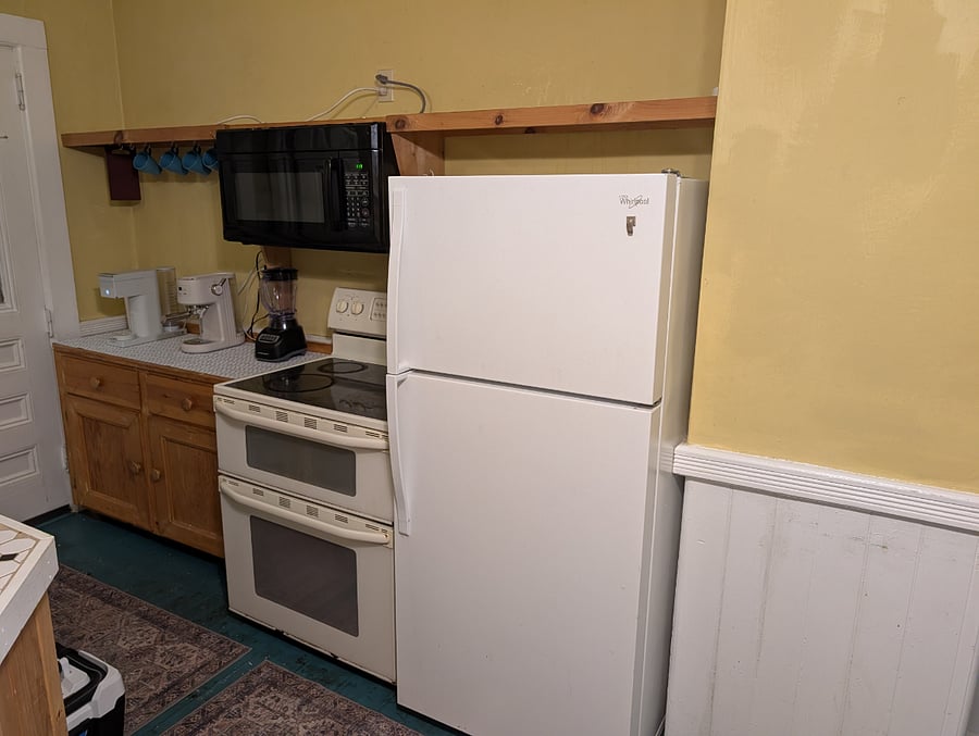 The kitchen has a full-sized refrigerator, coffee nook, blender, and large microwave.