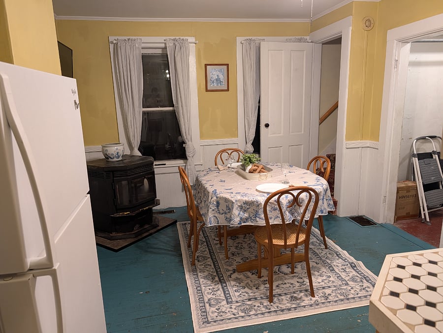 Kitchen and dining room with pellet stove and large hallway closet/storage area.