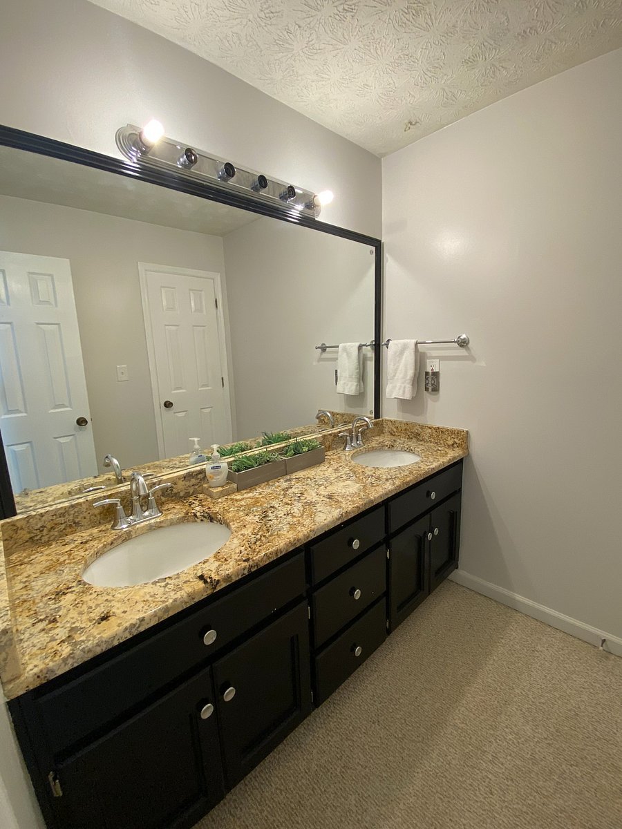 Upstairs shared bath with dual sinks.