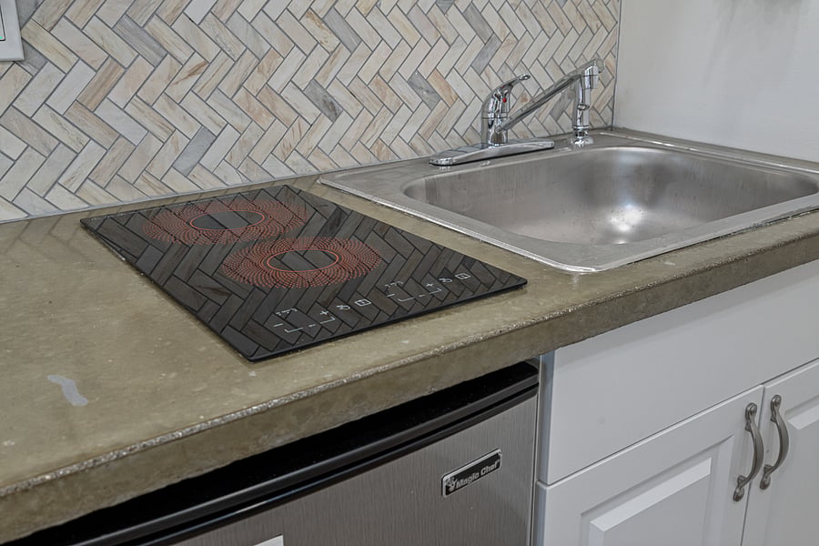 Kitchenette amenities: two-burner stove and large sink.