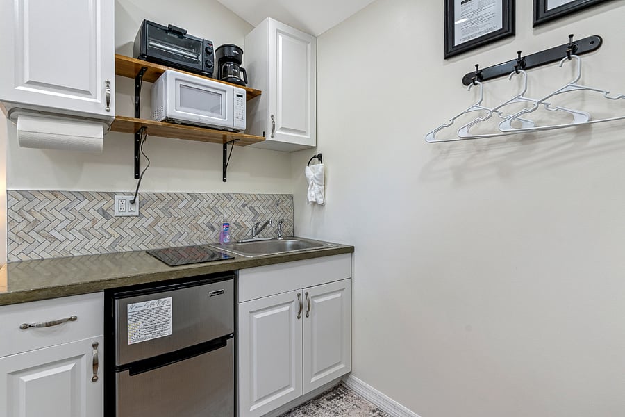 The kitchenette features a 2-burner stove, fridge and freezer, full size sink, toaster oven, and coffeepot. There's also hanging space for your belongings!