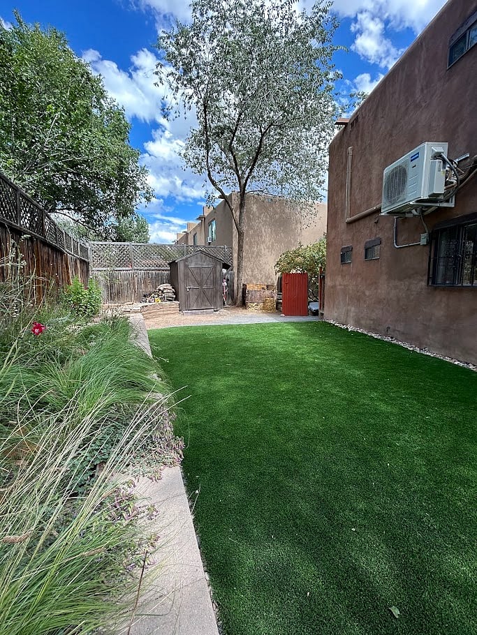 The backyard is shaded throughout the day. The large turf lawn is great for playing with kids.