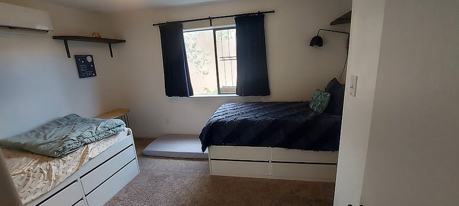 Two double beds in the east bedroom with ample storage and reading lights. All bedroom lights are dimmable.
