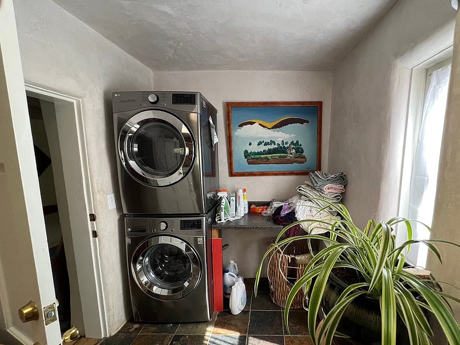 Laundry in guest bathroom. Bathroom facilities behind you, 2nd bedroom to your left, back door to your right)