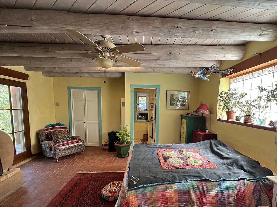 Master bedroom, looking towards master bath (door is next to dining room, windows on left share same view as big front deck, glass bricks above bed face out to upper driveway)