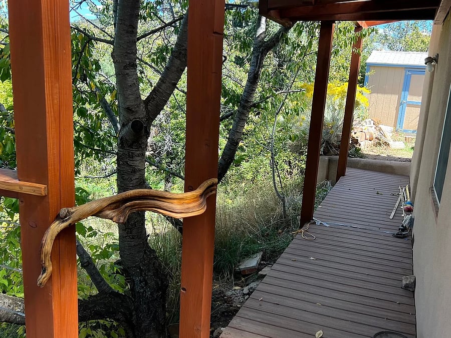 walkway connecting large front deck to upper driveway with door into master bedroom