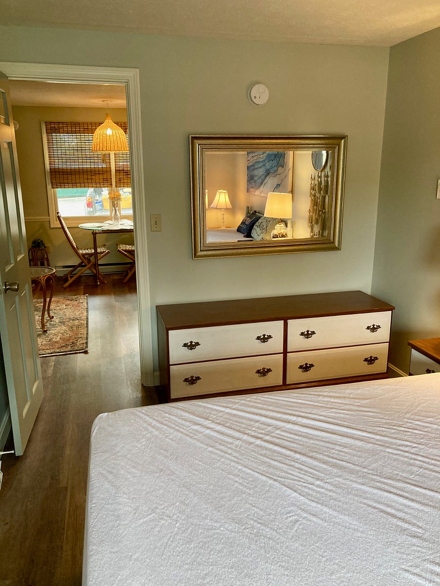 Bedroom features a queen bed, hutch and small closet