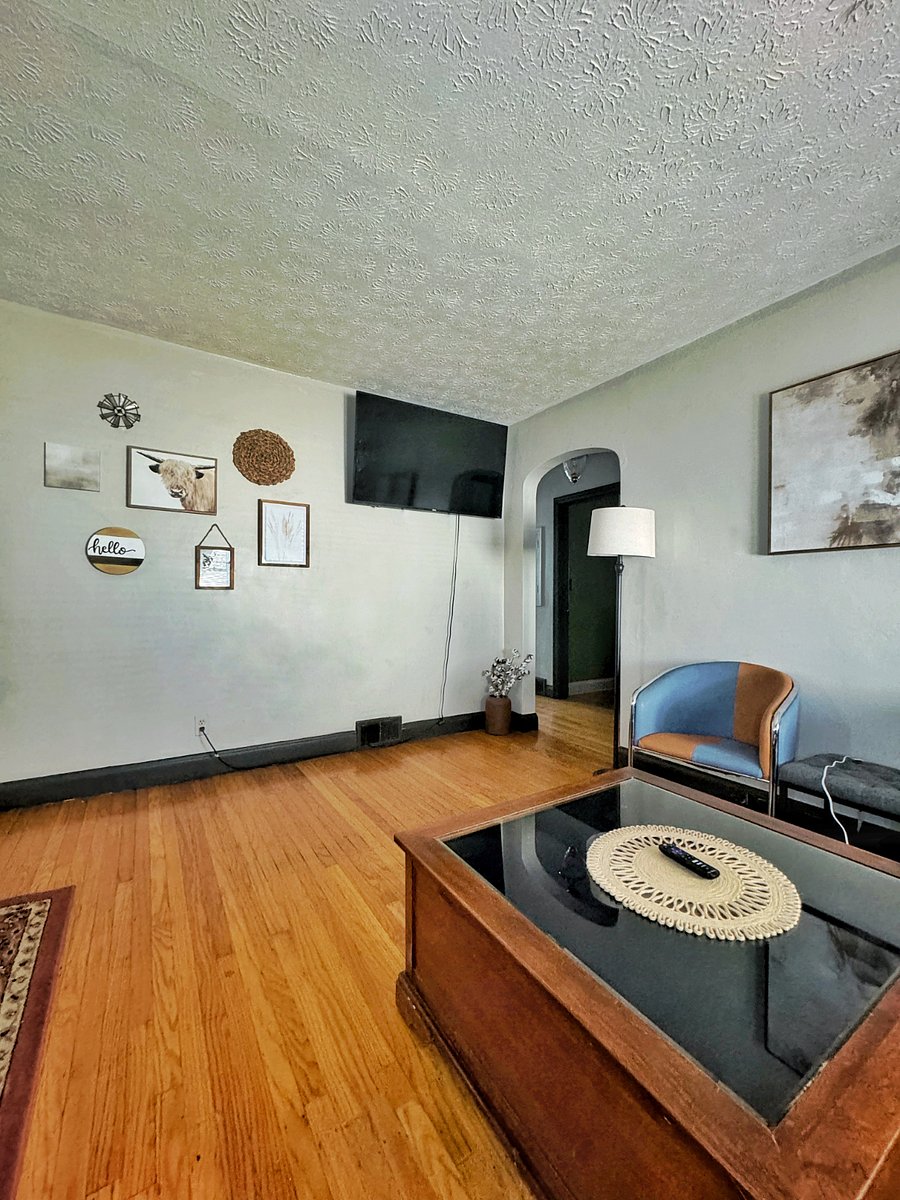 Bright, Comfortable Living Room Relax after long shifts with cozy seating and a Smart TV for streaming.