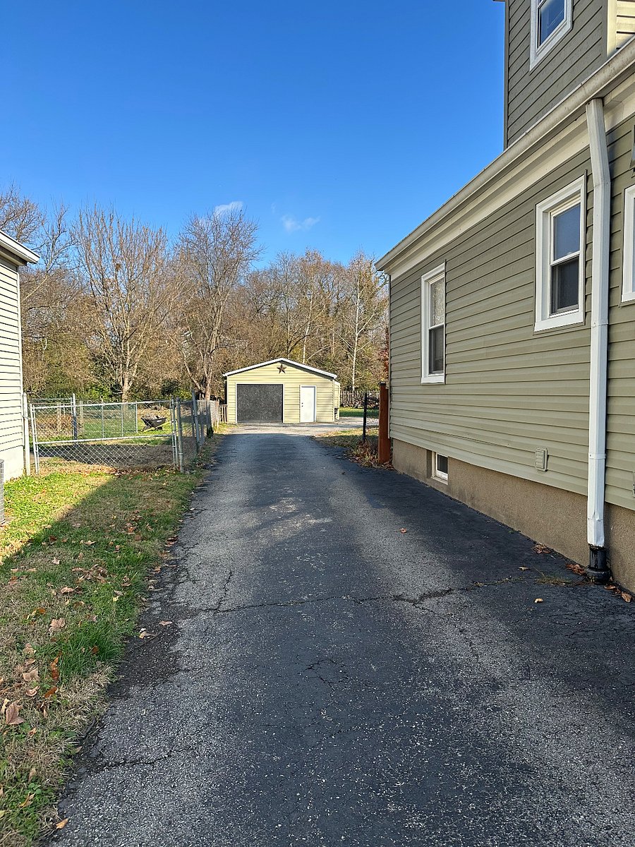 Private driveway with additional paved parking in the back