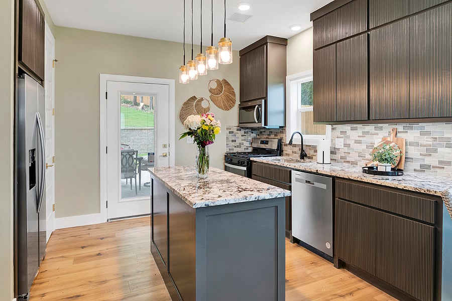 An open, airy kitchen with an island and pantry, thoughtfully equipped with everyday essentials for easy, enjoyable cooking.