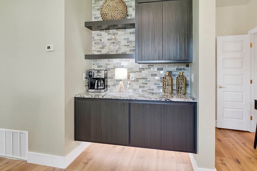 Dedicated coffee bar with modern floating cabinetry and a premium Cuisinart coffee maker for an easy morning routine.