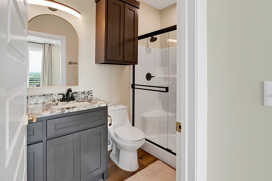 Spa-like primary bathroom with a spacious walk-in shower and modern finishes.