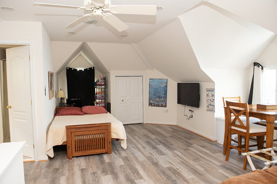 3rd floor loft with beds, smart tv, private bathroom, table & chairs and storage space.