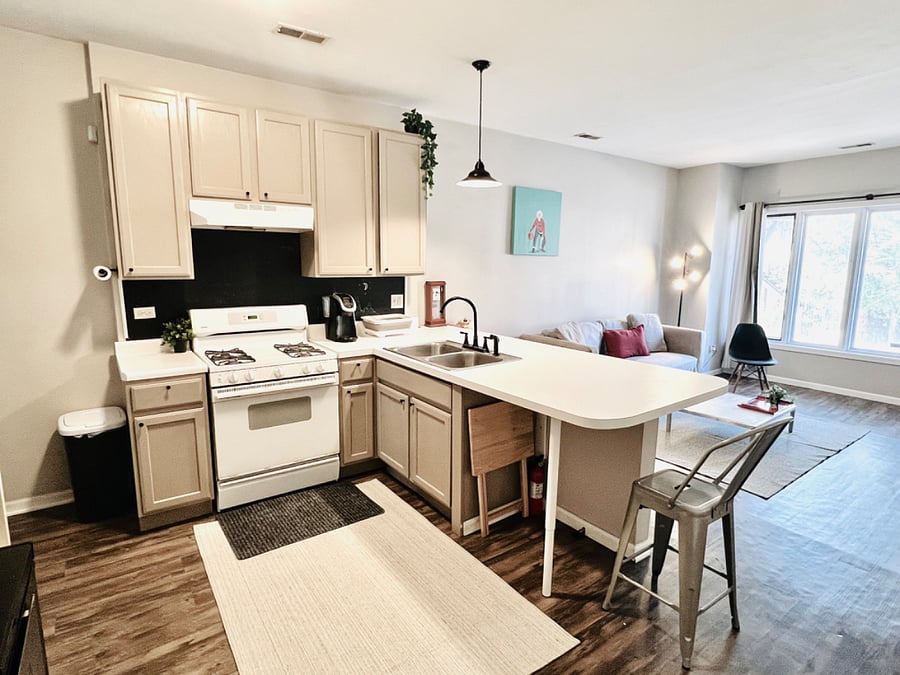 Full Kitchen with full size fridge, an extra freezer, stove/oven, and microwave