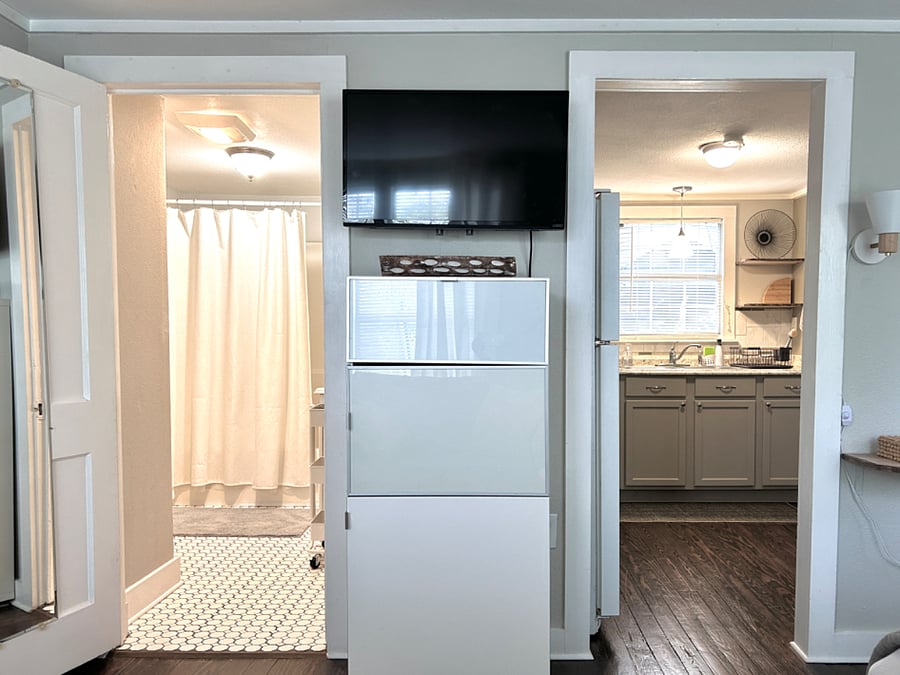 Roku smart tv on fully adjustable bracket, ample storage unit for clothing