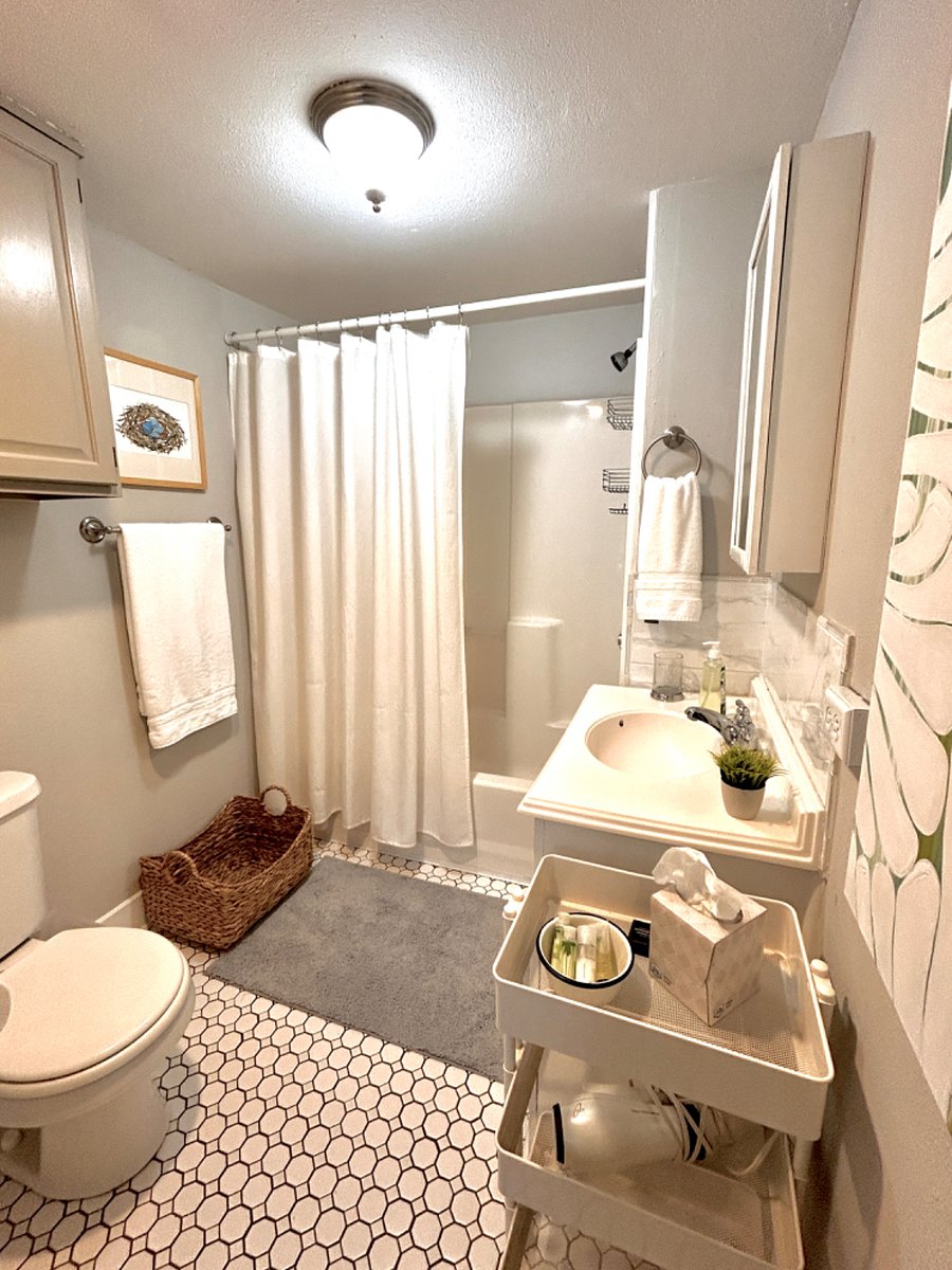 Spacious bathroom with full tub, plenty of storage